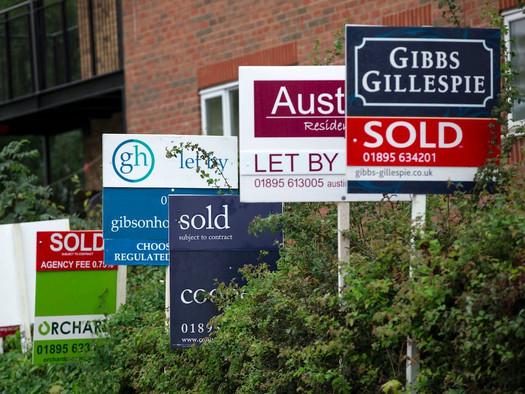 LONDON, ENGLAND - AUGUST 28: A row of estate agent boards are placed outside sold and let properties on August 28, 2014 in London, England.