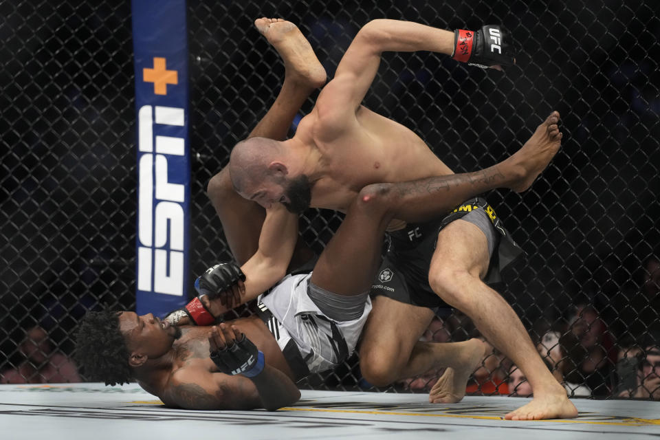 Khamzat Chimaev, right, fights Kevin Holland in a 180-pound catchweight bout during the UFC 279 mixed martial arts event Saturday, Sept. 10, 2022, in Las Vegas. (AP Photo/John Locher)