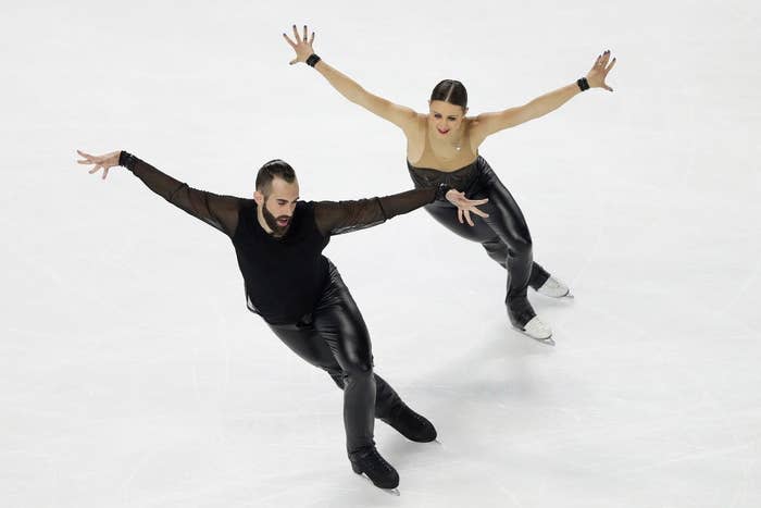 Timothy and Ashley skating side-by-side with their arms outstretched