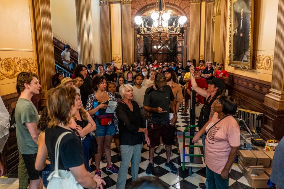 Attendees of a rally held by Rent Is Too Damn High coalition walk through the Michigan State Capitol building in Lansing on Tuesday, September 5, 2023, as part of the rally over renters rights and investment in affordable housing.