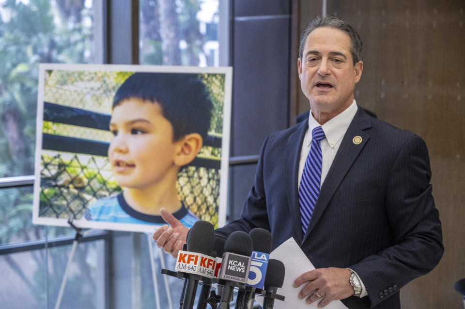 Orange County District Attorney Todd Spitzer speaks alongside a portrait of victim Aiden Leos during a news conference following the sentencing of Marcus Eriz, Friday, April 12, 2024., Friday, April 12, 2024, in Santa Ana, Calif. Eriz was sentenced Friday to 40 years to life for the fatal shooting of a 6-year-old boy who was riding in the back of his mother's car on the freeway, prosecutors said. (Mark Rightmire/The Orange County Register via AP)