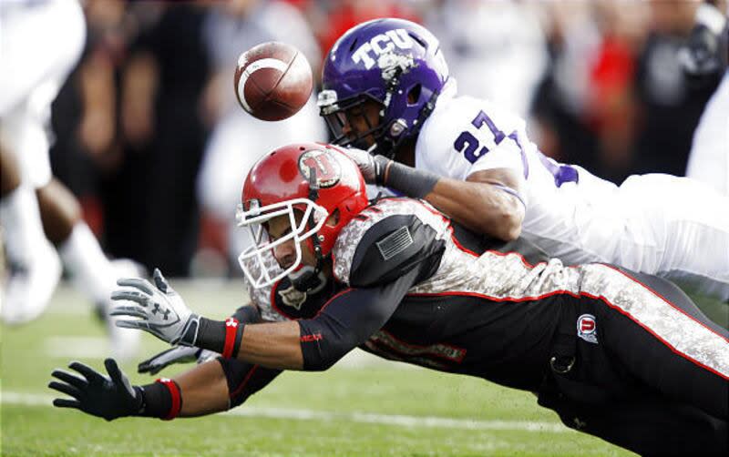 Utah's Luke Matthews can't make the catch with TCU's Jason Teague defending on Saturday at Rice-Eccles Stadium.