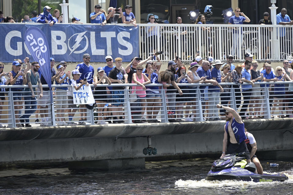 Tampa Bay Lightning defenseman Erik Cernak acknowledges fans from a personal watercraft during the NHL hockey Stanley Cup champions' Boat Parade, Monday, July 12, 2021, in Tampa, Fla. (AP Photo/Phelan M. Ebenhack)