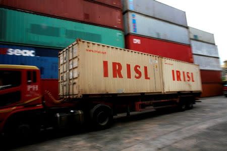 FILE PHOTO: A truck carrying Islamic Republic of Iran Shipping Lines (IRISL) containers arrives a depot in northern Singapore February 4, 2012. REUTERS/Thomas White/File Photo