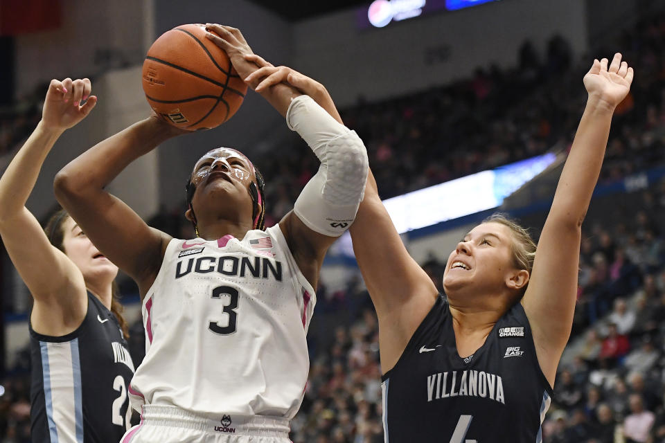 UConn's Aaliyah Edwards (3) is fouled by Villanova's Kaitlyn Orihel (4) in the first half of an NCAA college basketball game, Sunday, Jan. 29, 2023, in Hartford, Conn. (AP Photo/Jessica Hill)