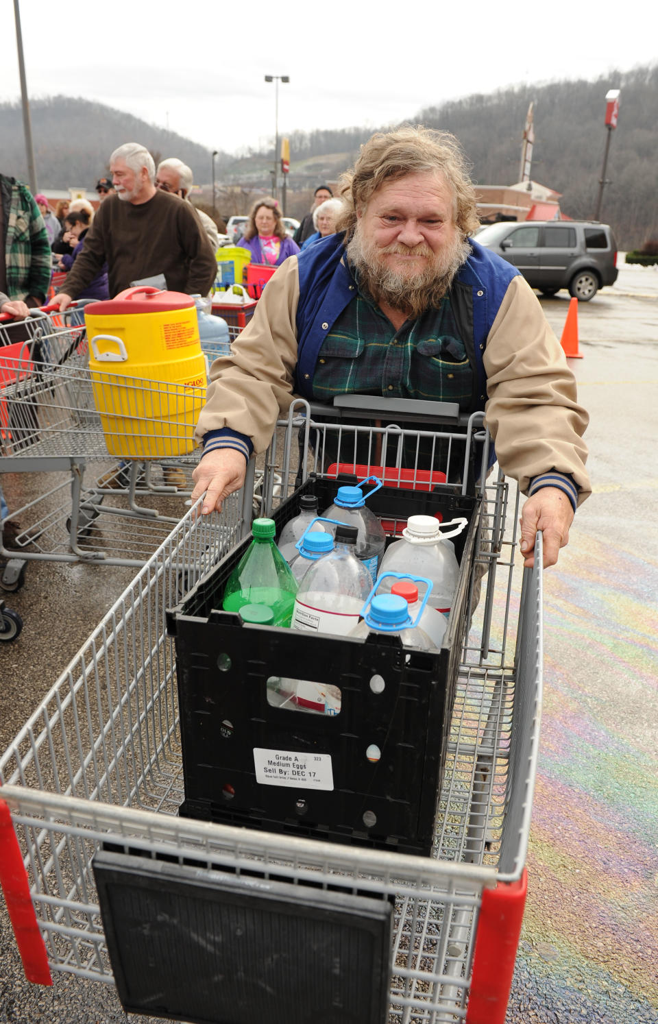 Homer Larch of Pinch W.Va. waits to get safe water at the Kmart in Elkview W.Va., Friday, Jan. 10, 2014. Emergency crews have brought in water at many locations around the state following a chemical spill Thursday on the Elk River that compromised the public water supply to nine counties. (AP Photo/Tyler Evert)