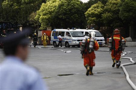 Rescuers walk in a refrigeration unit of Shanghai Weng's Cold Storage Industrial Co. Ltd., in the Baoshan district of Shanghai August 31, 2013. REUTERS/Aly Song