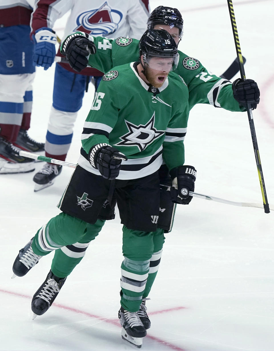 Dallas Stars center Joe Pavelski (16) celebrates his goal with Roope Hintz (24) during the first period of an NHL hockey game against the Colorado Avalanche in Dallas, Friday, Nov. 26, 2021. (AP Photo/LM Otero)