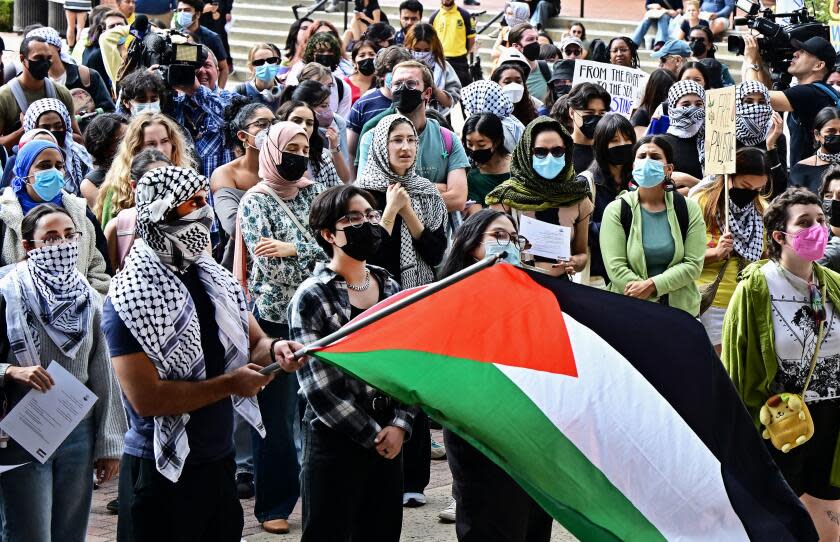 A person holds a Palestinian flag as students participate in a "Walkout to fight Genocide and Free Palestine" at Bruin Plaza at UCLA (University of California, Los Angeles) in Los Angeles on October 25, 2023. Thousands of people, both Israeli and Palestinians have died since October 7, 2023, after Palestinian Hamas militants based in the Gaza Strip, entered southern Israel in a surprise attack leading Israel to declare war on Hamas in Gaza the following day. (Photo by Frederic J. BROWN / AFP) (Photo by FREDERIC J. BROWN/AFP via Getty Images)