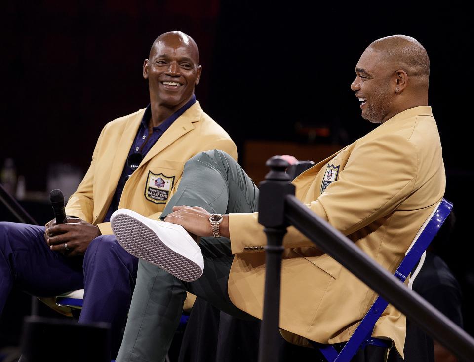 Bryant Young, left, and Richard Seymour share a laugh during the Class of 2022 Pro Football Hall of Fame roundtable Sunday in Canton, Ohio. After an impassioned plea from former offensive linemen who played against him, the selection committee voted Young into the Hall on his 10th try.