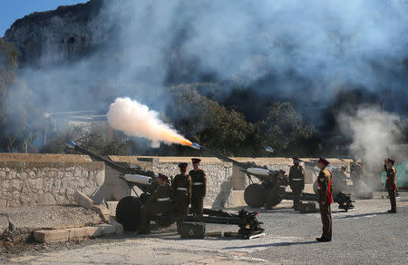 Members of the Royal Gibraltar Regiment fire a 21-gun salute to mark the 67th anniversary of Britain's Queen Elizabeth's accession to the throne, in front of the Rock in the British overseas territory of Gibraltar, historically claimed by Spain February 6, 2019. REUTERS/Jon Nazca