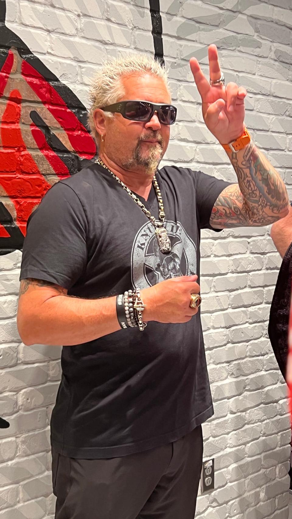 Guy Fieri poses for the media in front of the Chicken Guy! Nashville mural on May 4, 2022