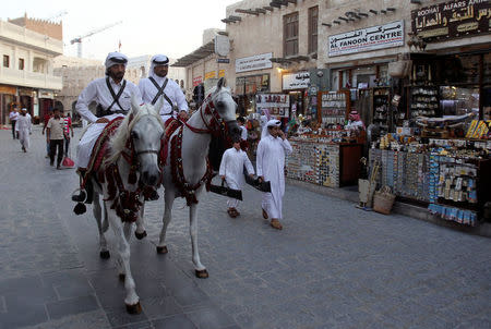 Qatari men ride horses as they parade at Souq Waqif market in Doha, Qatar August 30, 2016. REUTERS/Naseem Zeitoon