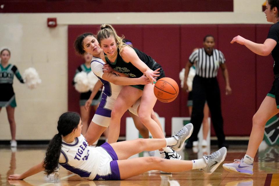 Dublin Coffman's Jenna Kopyar (22) battles Pickerington Central's Olivia Cooper (15) and Blossom Wallace.