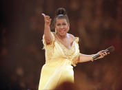 <p>Aretha Franklin wears a yellow empire dress with beaded details along the sleeve and bust while performing at the inaugural gala for U.S. President Bill Clinton in Washington D.C. (AP Photo/Amy Sancetta) </p>