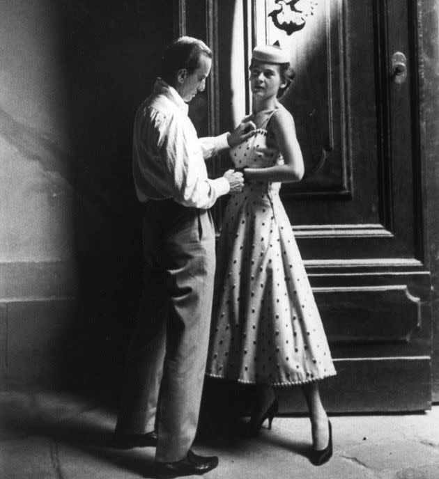 Italian fashion and fabric designer Emilio Pucci works with one of his fit models circa 1954.