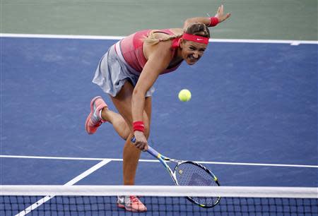 Azarenka of Belarus hits a return to Serena Williams of the U.S. during their women's singles final match at the U.S. Open tennis championships in New York