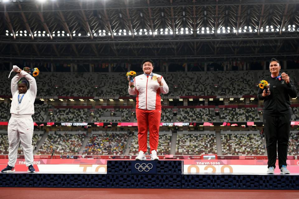 Raven Saunders (left) protested on the medal stand after earning silvler in shot put. (Photo by INA FASSBENDER/AFP via Getty Images)