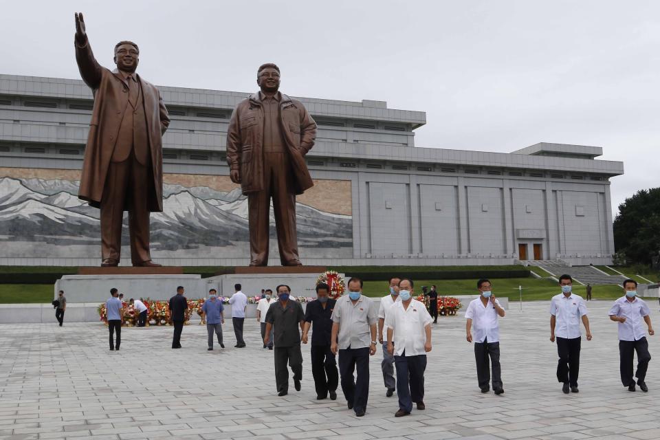 People visit the statues of former North Korean leaders Kim Il Sung, left, and Kim Jong Il, right, to lay flowers on the occasion of the 67th anniversary of the end of the Korean War, which the country celebrates as the day of "victory in the fatherland liberation war" in Pyongyang, Monday, July 27, 2020. (AP Photo/Jon Chol Jin)