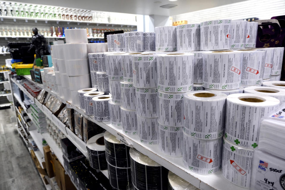 This Wednesday, Aug. 28, 2019, photo shows what appears to be official California State cannabis labels for sale on a shop shelf in downtown Los Angeles. A short walk from police headquarters in the heart of downtown, a cluster of bustling shops are openly selling packaging and hardware that can be used to produce counterfeit, and potentially dangerous, marijuana vapes that have infected California's cannabis market and possibly sickened dozens of people. (AP Photo/Richard Vogel)