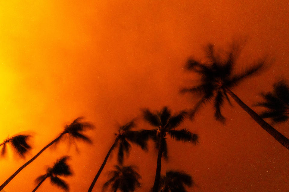 Wildfires burn over the town of Lahaina as seen in the neighboring Kaanapali Alii resort