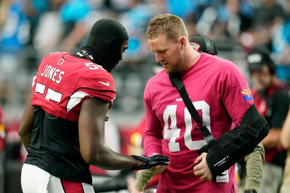 Arizona Cardinals outside linebacker Chandler Jones, left, talks with injured Cardinals' J.J. Watt prior to an NFL football game against the Carolina Panthers Sunday, Nov. 14, 2021, in Glendale, Ariz. (AP Photo/Darryl Webb)