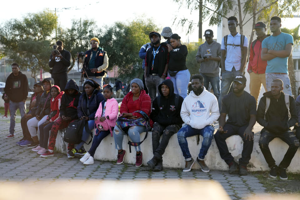 Haitian migrants listen to immigration attorneys giving updates on their current asylum status, Tuesday, Dec. 20, 2022, in Tijuana, Mexico. The U.S. government made its plea in a filing a day after Chief Justice John Roberts issued a temporary order to keep the pandemic-era limits on migrants in place. (AP Photo/Marcio Jose Sanchez)