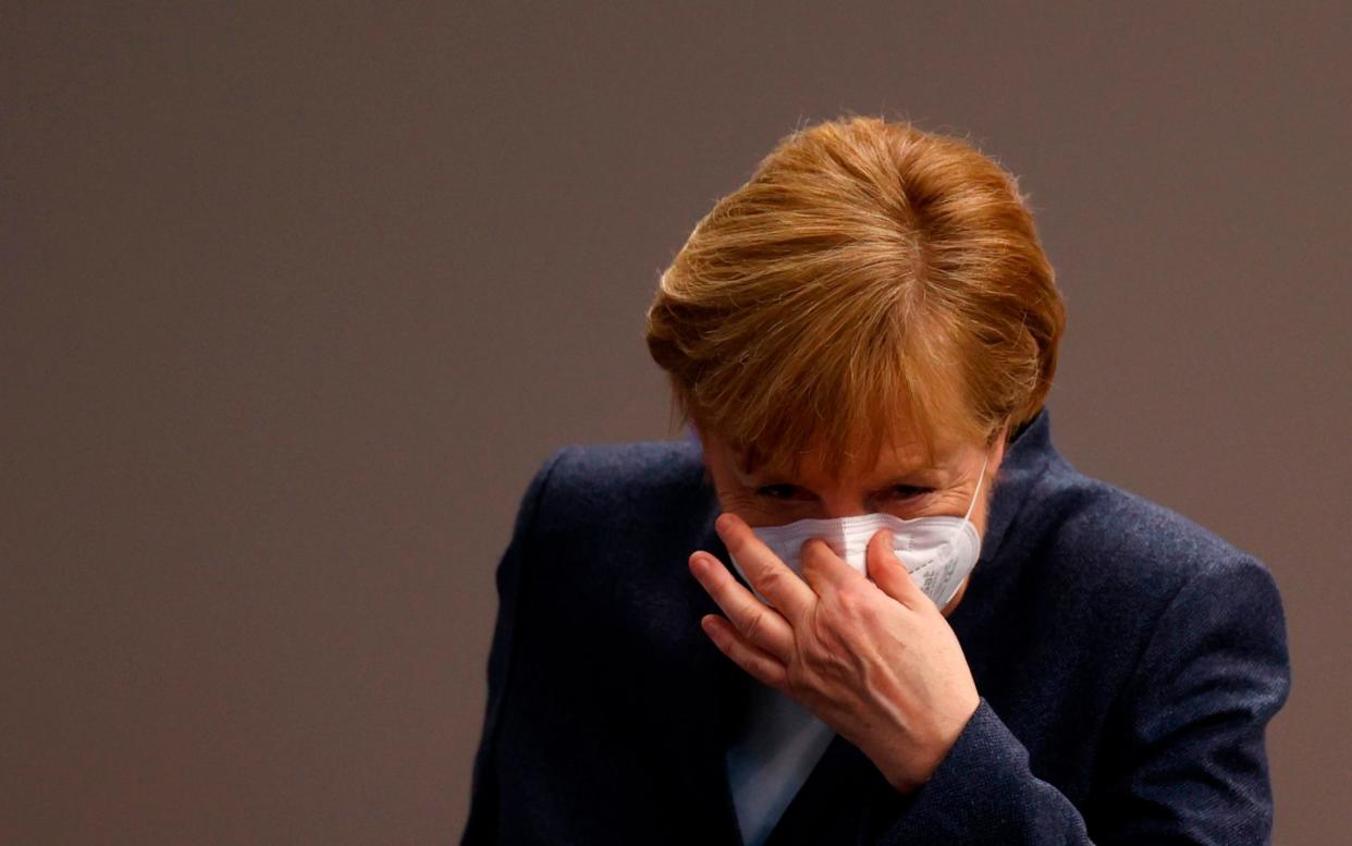 (FILES) In this file photo taken on December 16, 2020 German Chancellor Angela Merkel puts her face protection mask on after a session of the Bundestag (lower house of parliament) in Berlin, amid the coronavirus Covid-19 pandemic. - Chancellor Angela Merkel on January 16, 2021 said significantly tougher measures were needed to slow Germany's coronavirus infections, party sources told AFP. Speaking at a meeting with top brass from her centre-right CDU party, Merkel said "the virus can only be stopped with significant additional efforts", participants told AFP, adding that the chancellor wanted to hold fresh crisis talks with regional leaders next week. (Photo by Odd ANDERSEN / AFP) (Photo by ODD ANDERSEN/AFP via Getty Images) - ODD ANDERSEN/AFP