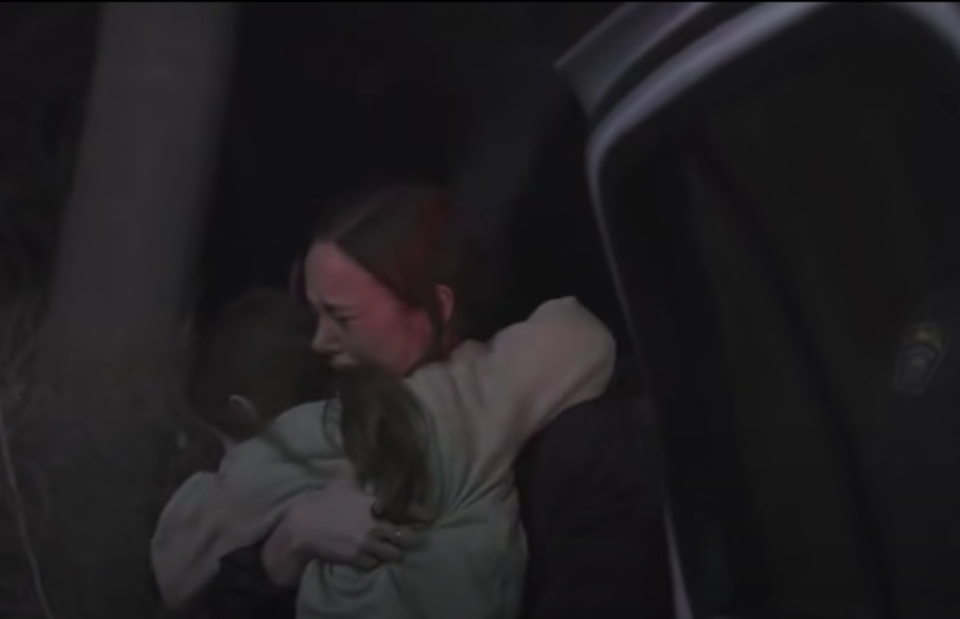 Larson hugging her character's son in room