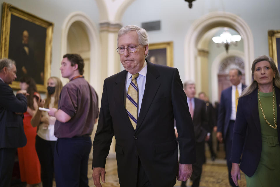 Senate Minority Leader Mitch McConnell, R-Ky., joined at right by Sen. Joni Ernst, R-Iowa, arrives to meet with reporters following a weekly strategy luncheon, at the Capitol in Washington, Tuesday, July 20, 2021. (AP Photo/J. Scott Applewhite)