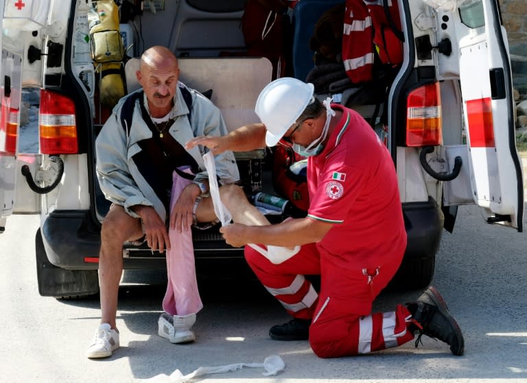 A man receives a medical assistance in the central Italian village of Illica on August 24, 2016