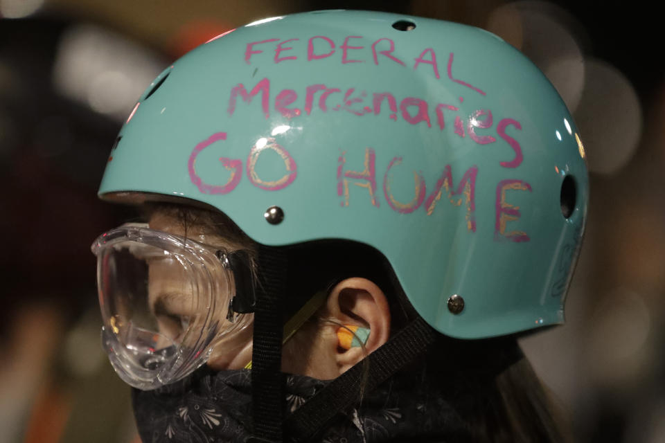 A demonstrator's protective helmet reads "Federal Mercenaries Go Home" during a Black Lives Matter protest at the Mark O. Hatfield United States Courthouse Sunday, July 26, 2020, in Portland, Ore. (AP Photo/Marcio Jose Sanchez)