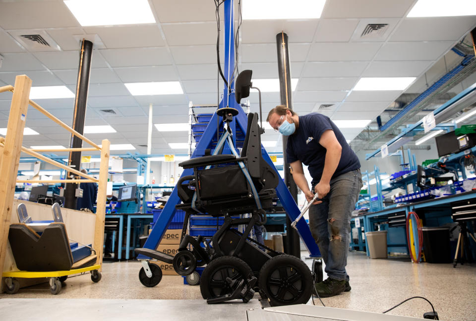  Lead technician Brian Dean is seen installing a test seat to perform a final acceptance test of the iBOT power base on May 4, 2021, at Mobius Mobility headquarters in Manchester, New Hampshire. (Kayana Szymczak for Yahoo News)


