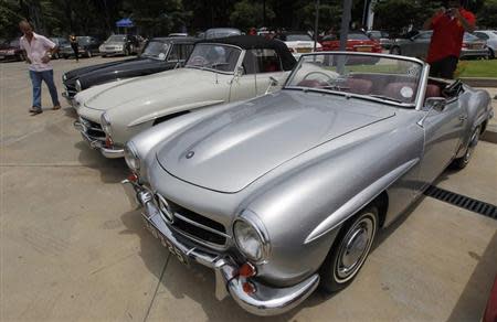 A man walks past a row of 1954 Mercedes-Benz cars at an annual Mercedes-Benz pageant in Colombo September 15, 2013. REUTERS/Dinuka Liyanawatte