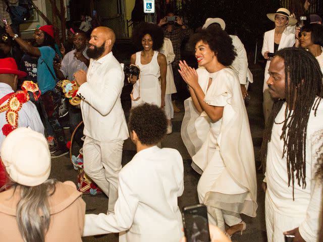 <p>Josh Brasted/WireImage</p> Solange Knowles and Alan Ferguson on the streets of New Orleans following their wedding on Nov. 16, 2014
