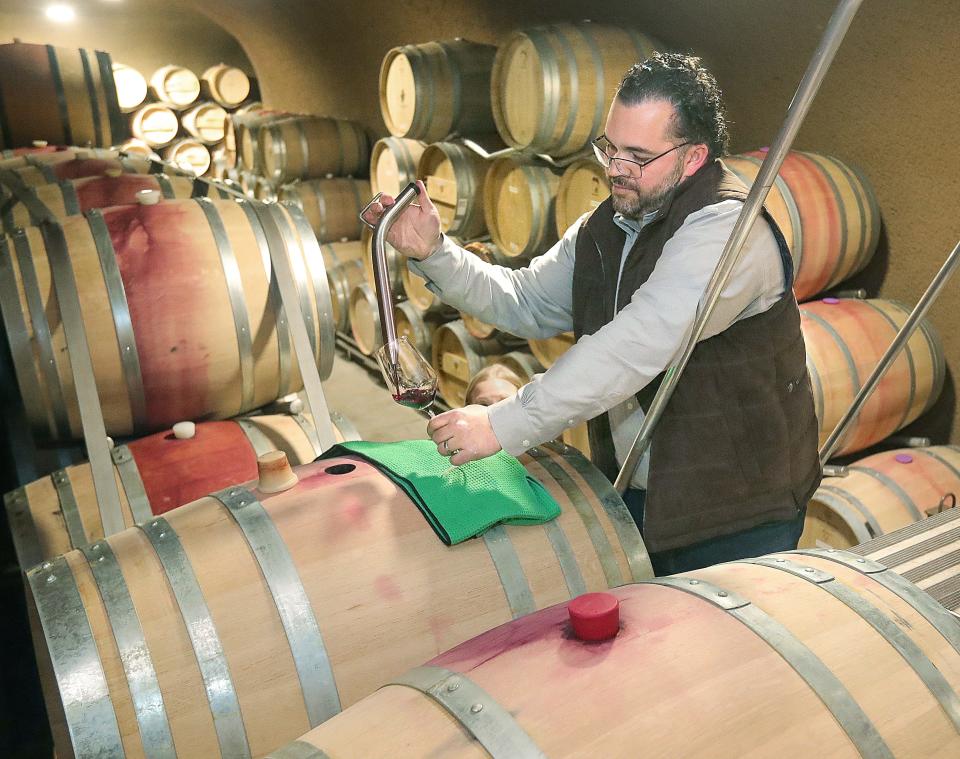 Julian Christian extracts a barrel sample of his Coombsville cabernet at The Caves at Soda Canyon in Napa, California. They plan to release the wine in 2025.