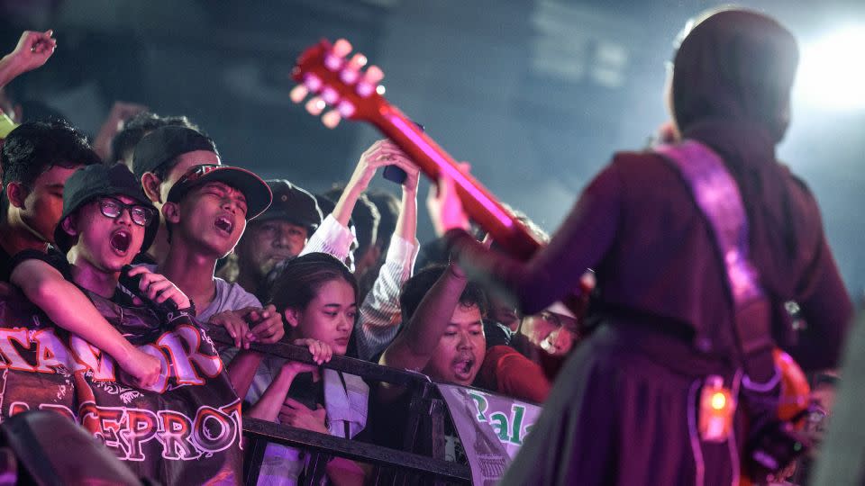 Fans go wild as VOB vocalist and guitarist Firda Kurnia performs on stage during a concert in Jakarta. - Bay Ismoyo/AFP/Getty Images