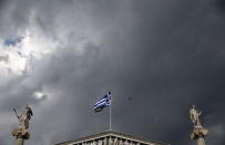 A Greek national flag flutters next to statues of ancient Goddess Athena (L) and God Apollo atop the Athens Academy June 10, 2015. REUTERS/Alkis Konstantinidis