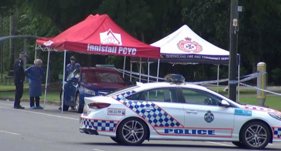 Police are seen at the cordoned off park in Innisfail.