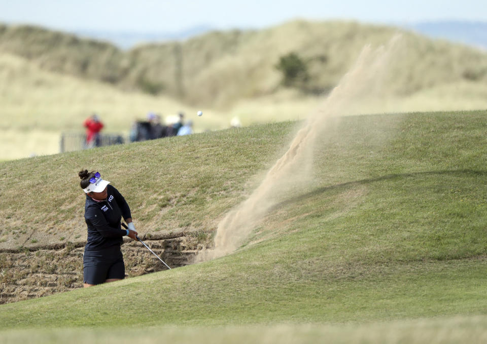 Megan Khang of United States' plays her shot from the bunker at the 17th during the second round of the Women's British Open golf championship, in Muirfield, Scotland Friday, Aug. 5, 2022. (AP Photo/Scott Heppell)