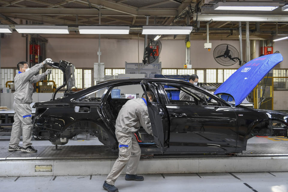 In this Feb. 17, 2020, file photo released by Xinhua News Agency, workers assemble Audi A6 L cars at a workshop of FAW-Volkswagen Automobile Co., Ltd. in Changchun, northeast China's Jilin Province.Factories that make the world's smartphones, toys and other goods are struggling to reopen after a virus outbreak idled China's economy. But even with the ruling Communist Party promising help, companies and economists say it may be months before production is back to normal. (Zhang Nan/Xinhua via AP, File)