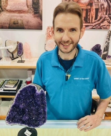 Jason Thomas, retail manager at Spirit of the Earth holds a Amethyst geode. The stone is used to create tranquility in any space.