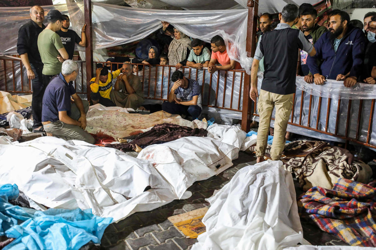 The bodies of the dead in a bombing on Al-Ahli hospital are gathered outside Al-Shifa hopsital, in Gaza. (Dawood Nemer / AFP - Getty Images)