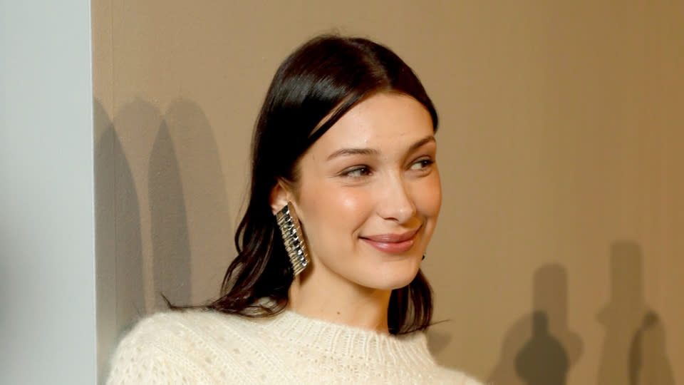 “I was totally there," the supermodel said od her anxiety. "My sister [Gigi Hadid] is very bubbly and very out there, and <a href="https://people.com/tv/bella-hadid-opens-up-about-anxiety-while-coaching-aspiring-models/" rel="nofollow noopener" target="_blank" data-ylk="slk:I was always very reserved;elm:context_link;itc:0;sec:content-canvas" class="link ">I was always very reserved</a>. I would literally start crying and shaking if I had to do interviews at red carpet events. It was really nerve-racking and it’s scary, and it’s not only you. It gets a lot better once you have to talk to people every day,” she added. “Then you’re like, ‘Okay, I guess it’s my job, I have to do it!’