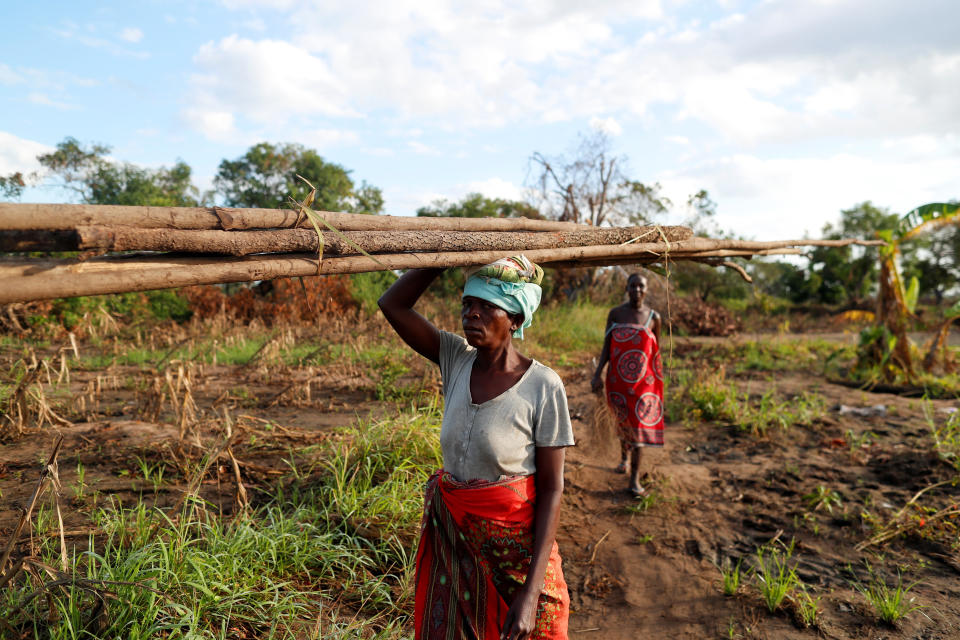 Maria Jofresse, 25, walks behind her mother-in-law Teresa Miquitaio, 49, as she carries wood to build a makeshift shelter in the aftermath of Cyclone Idai, outside the village of Cheia, which means "Flood" in Portuguese, near Beira, Mozambique April 2, 2019. Maria Jofresse lost her two children to the storm. In the midst of the floods, she dug their small graves but can't find them anymore. "People suffered indeed but no one suffered as I did because I lost the most precious things I had - my kids," she said. (Photo: Zohra Bensemra/Reuters) 