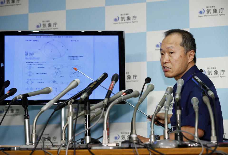 A section chief speaks at a press conference following a strong earthquake in northern Japan, at Japan Meteorological Agency in Tokyo Thursday, Sept. 6, 2018. A powerful earthquake struck the island of Hokkaido. (Kyodo News via AP)