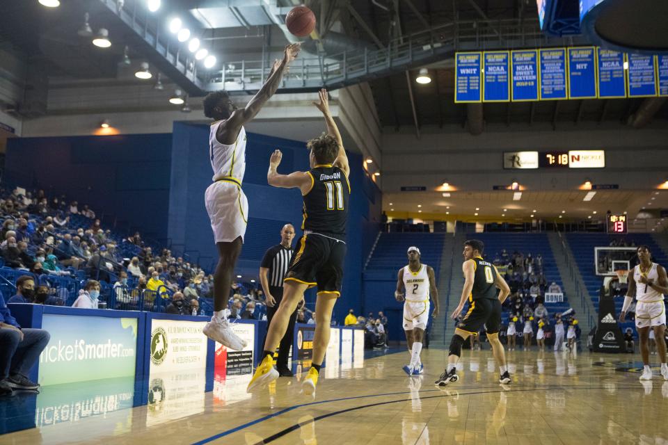 University of Delaware's Ebby Asamoah (14) attempts a 3-pointer during their game against Towson Monday, Jan. 24, 2022, at The Bob Carpenter Center. 