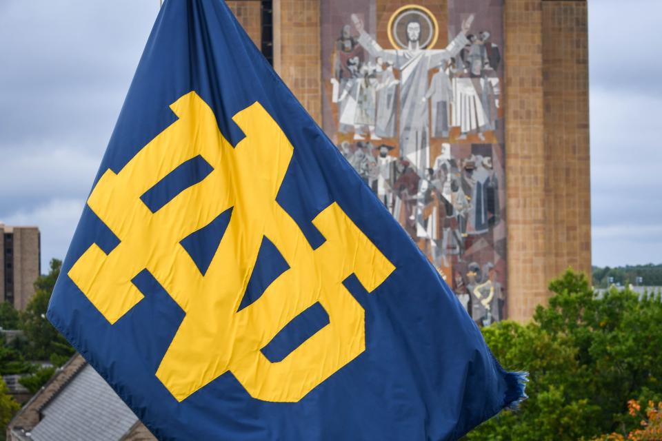 Sep 28, 2019; South Bend, IN, USA; A Notre Dame monogram flag waves in front of the Word of Life mural, commonly known as Touchdown Jesus, on the campus of the University of Notre Dame before the game between the Notre Dame Fighting Irish and the Virginia Cavaliers at Notre Dame Stadium. Mandatory Credit: Matt Cashore-USA TODAY Sports
