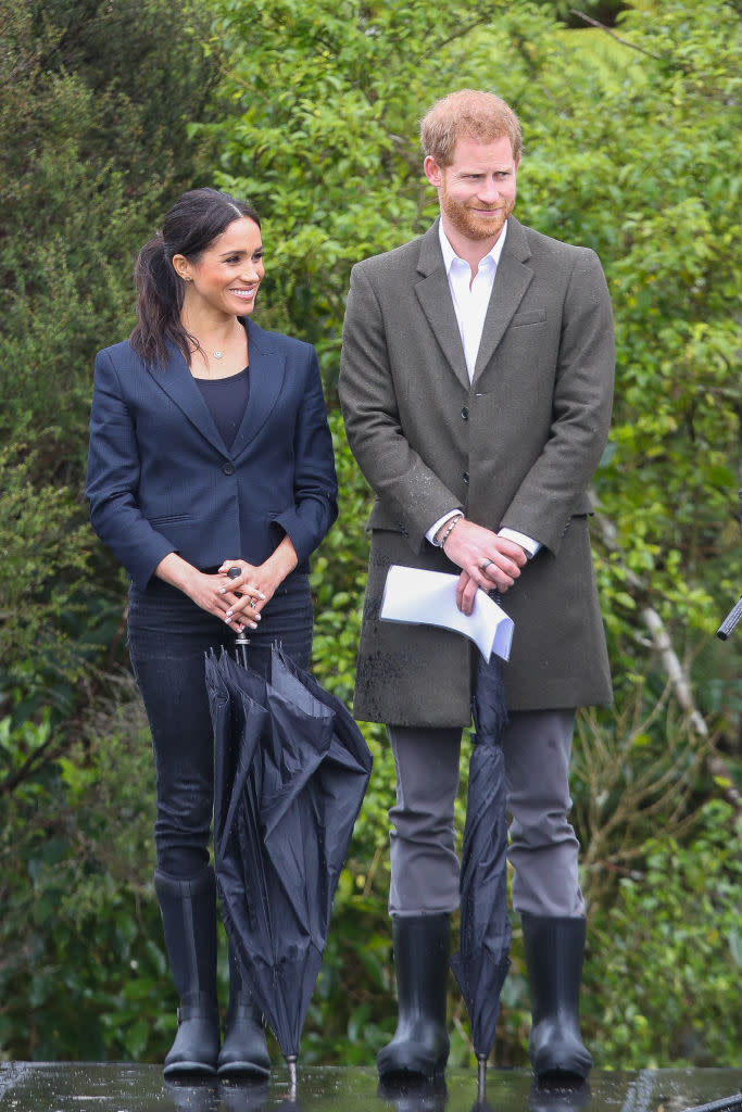 <p>It was a rainy start in New Zealand on October 30 so the royal couple donned matching wellies for the unveiling of The Queen’s Commonwealth Canopy in Redvale. The Duchess wore the aptly-named ‘Reign’ Muck Boots with £255 <a rel="nofollow noopener" href="https://www.karenwalker.com/clothing/jackets/fathom-jacket-60027-01/dark-navy" target="_blank" data-ylk="slk:blazer" class="link ">blazer</a> by Karen Walker. <em>[Photo: Getty]</em> </p>