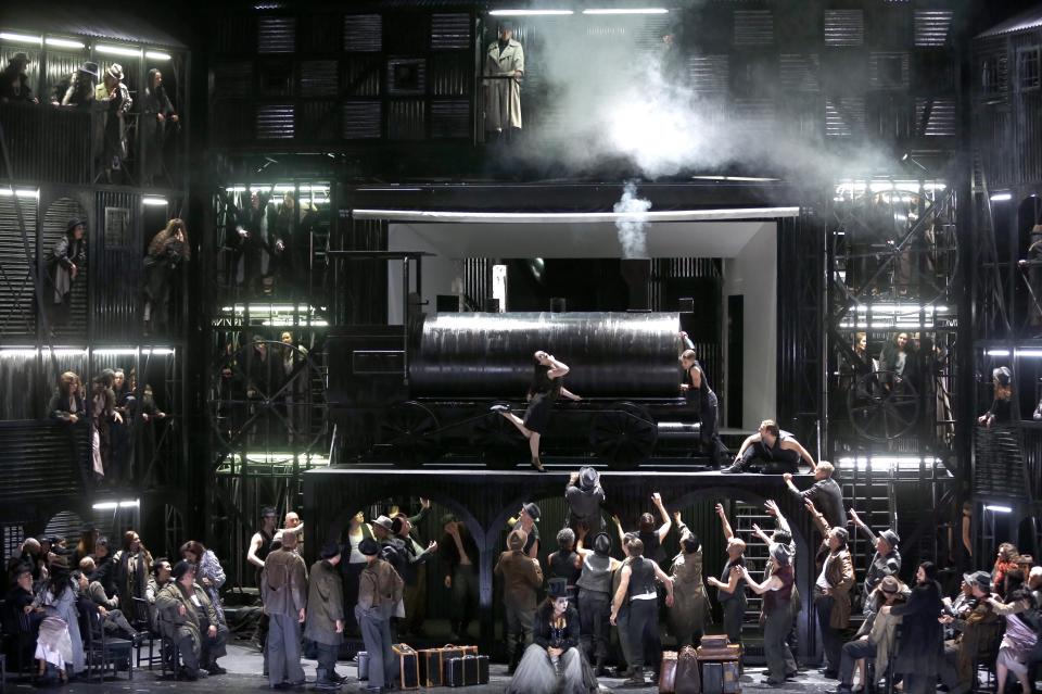 This picture taken Friday, June 21, 2013, shows a general view during a dress rehearsal for the opera "Il Trovatore" by Giuseppe Verdi in the Bavarian State Opera House in Munich, southern Germany. This wild new production by Olivier Py opened the company's annual Munich Opera Festival. It's a non-stop barrage of nightmarish images mixing styles and periods that assault the audience at lightning speed on a multi-tiered revolving set. (AP Photo/Matthias Schrader)